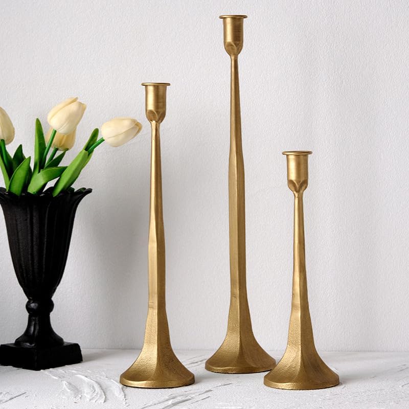 Set of three gold iron taper candle holders in graduated heights with a matte finish, perfect for adding vintage charm to a romantic French cottage bedroom.