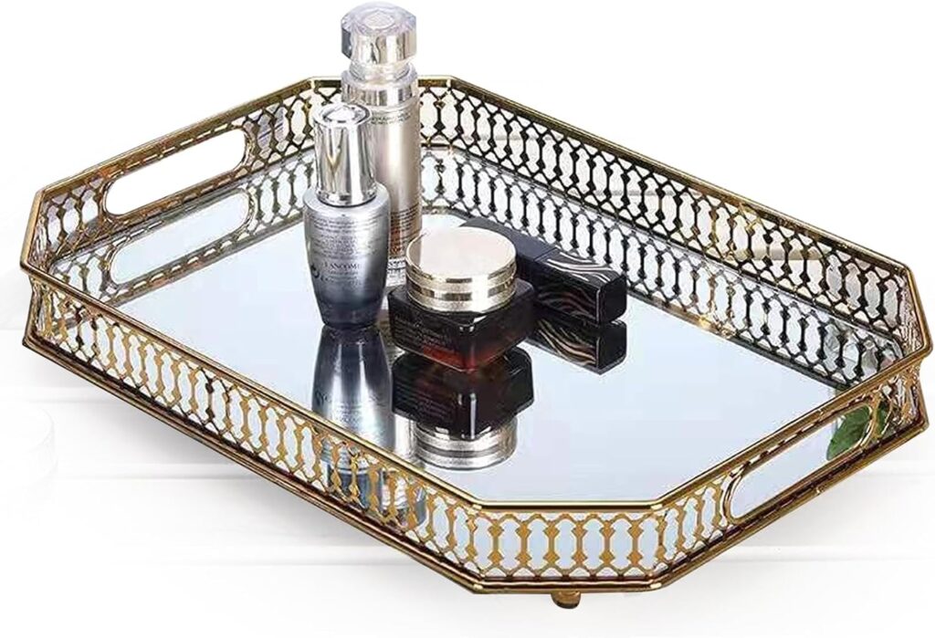 Mirrored gold vanity tray with intricate lattice border and handles, styled with perfume bottles and cosmetics, ideal for elegant bedroom or bathroom decor.